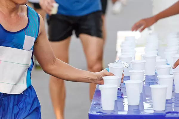 marathon runner getting water